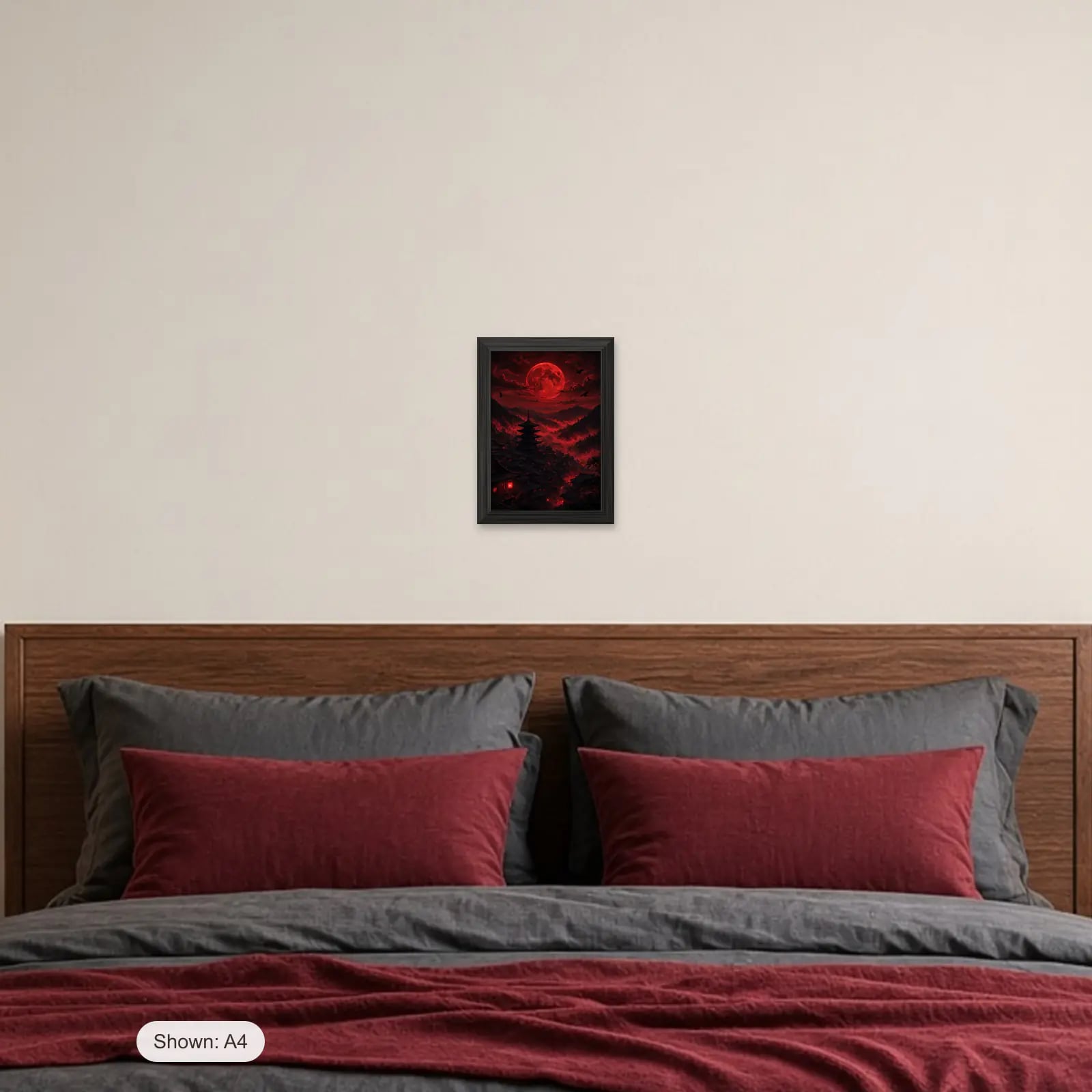 Blood Moon Village Frame above a bed with crimson pillows