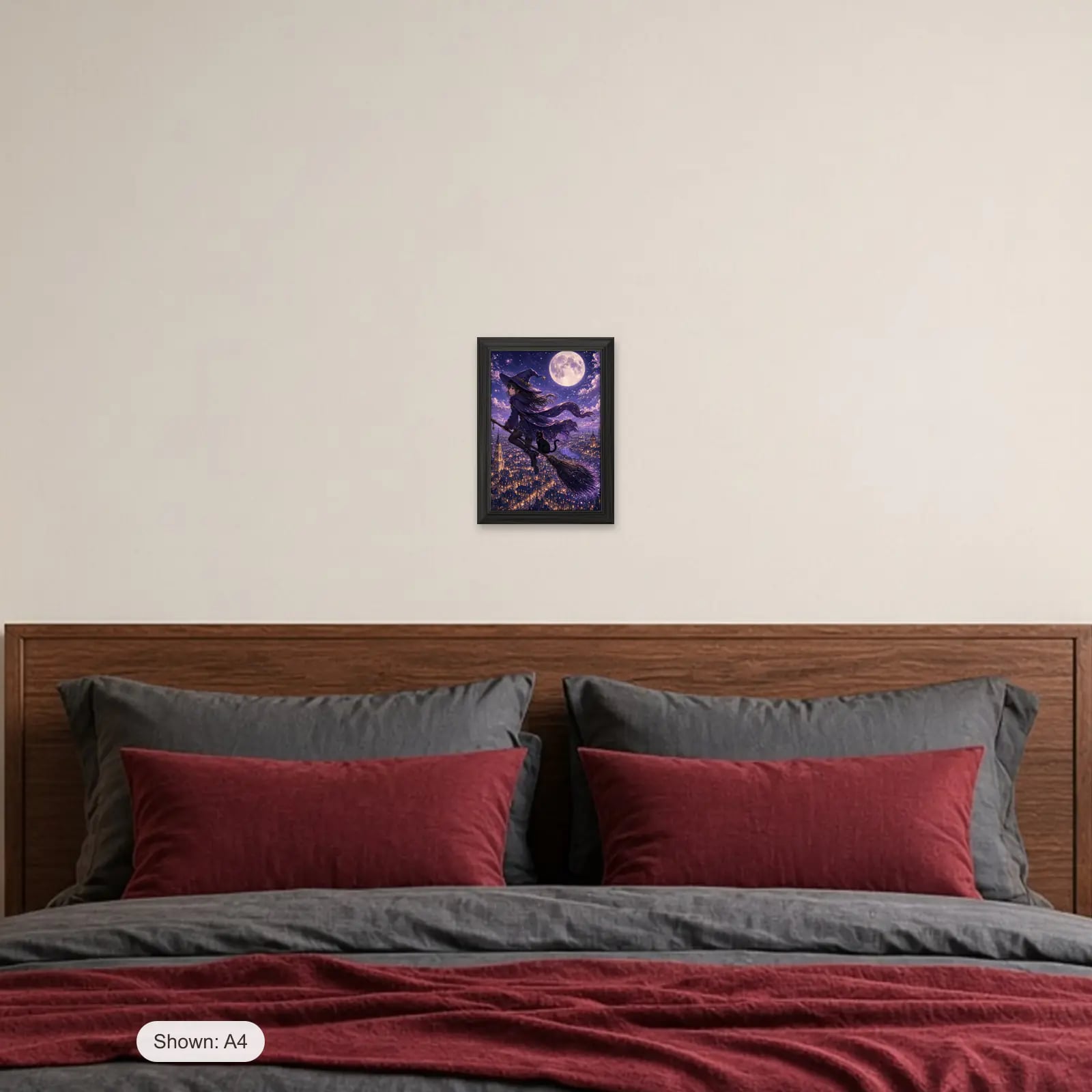 Starlight Witch Art Print above a bed with crimson pillows