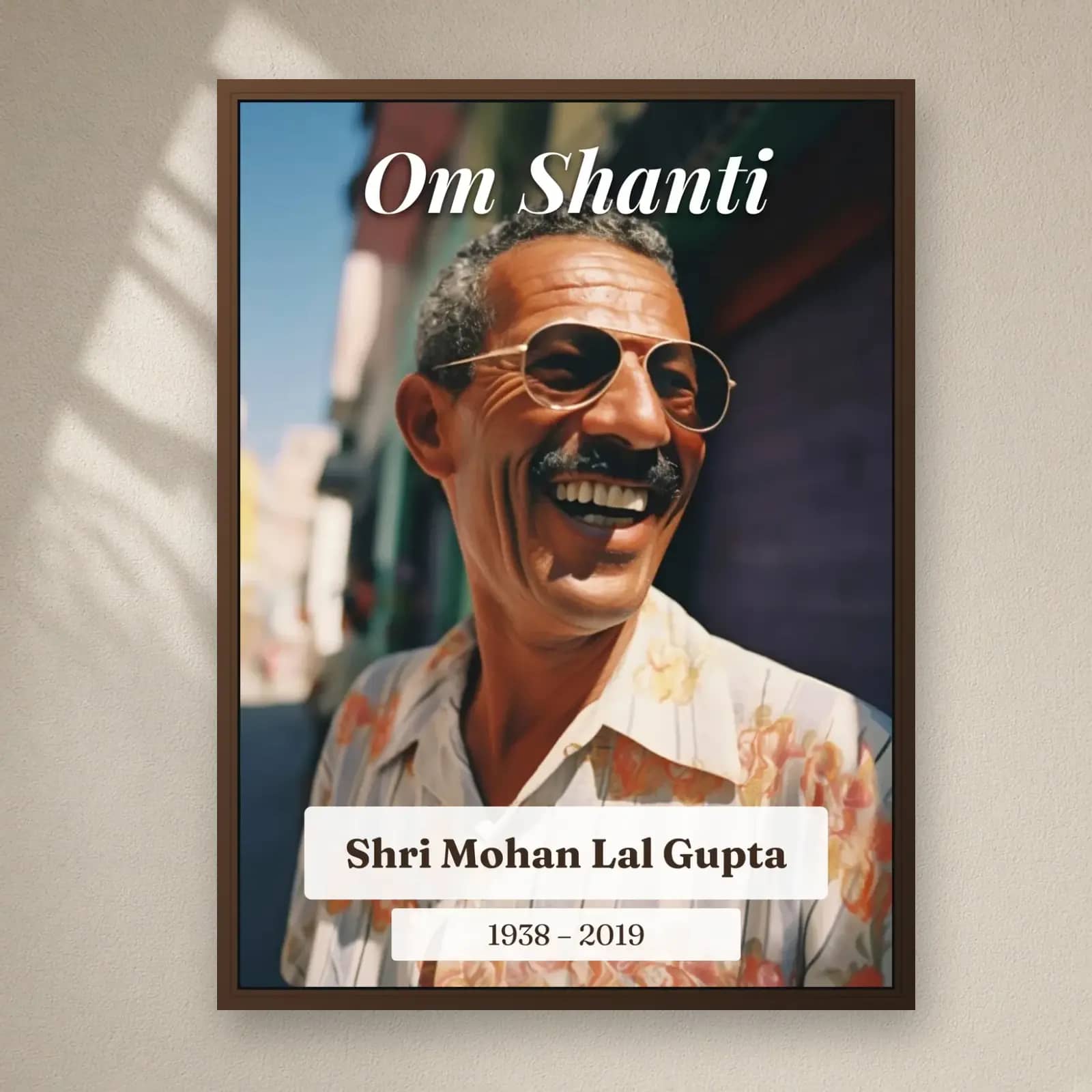 Om Shanti Memorial Frame on a plain wall